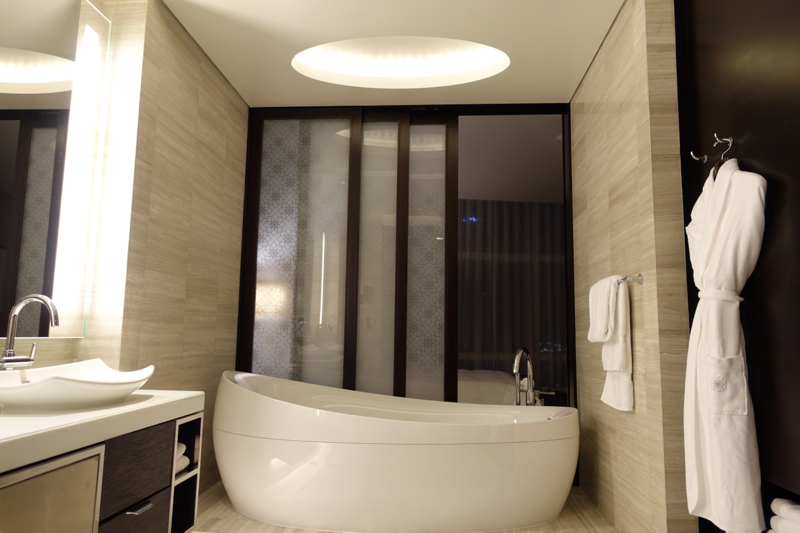 Rosewood Abu Dhabi Review-Oversized Bath Tub and Sliding Glass Partition Between Bathroom and Bedroom