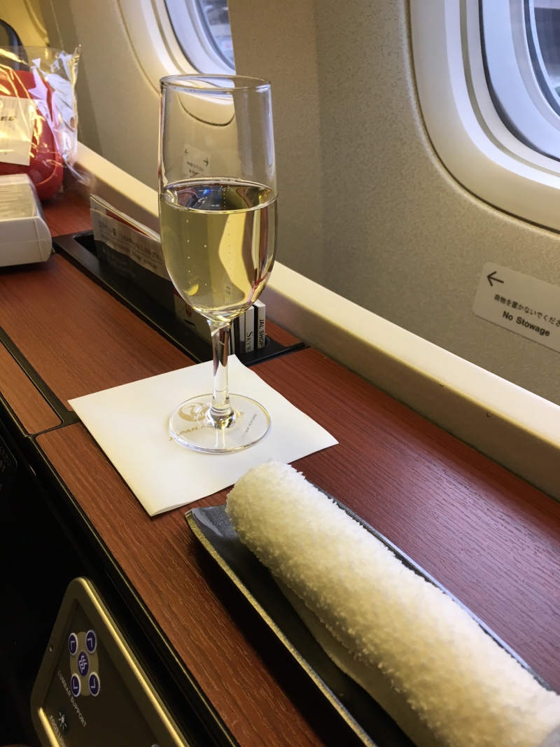 JAL First Class Review-Champagne Pre-Flight Drink and Oshibori