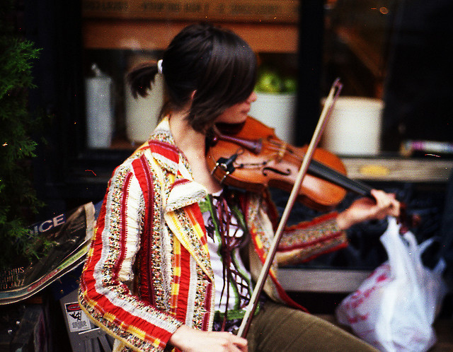 A violinist performs on Bedford Avenue, Brooklyn
