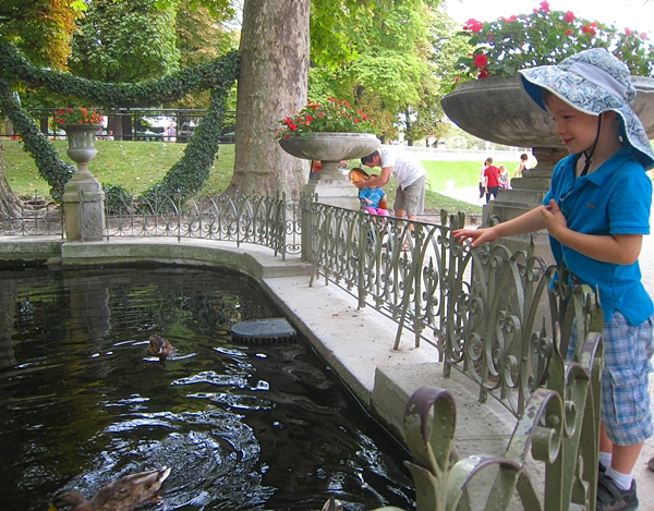 Feeding the ducks in Jardin du Luxembourg, Paris